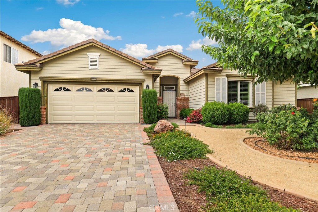 29936 Sycamore Ridge Road Murrieta, CA 92563 - Photo 1 of 1 a view of a white house with a small yard and large tree