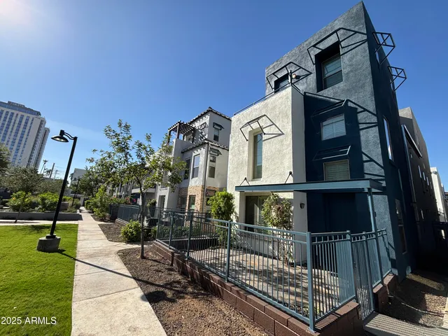a view of a house with a small yard and furniture