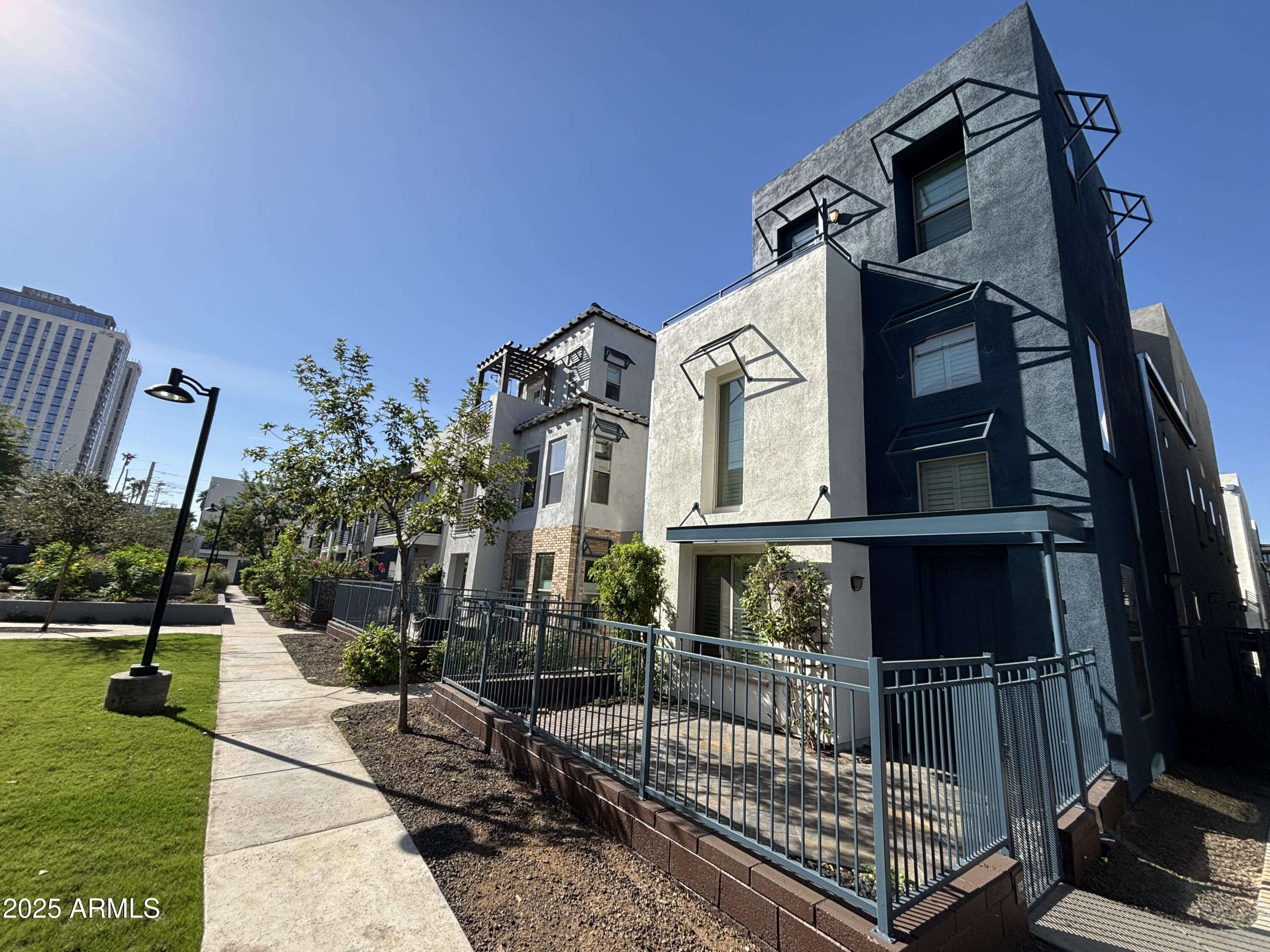 615 East Portland Street, Unit 113 Phoenix, AZ 85004 - Photo 1 of 28 a view of a house with a small yard and furniture
