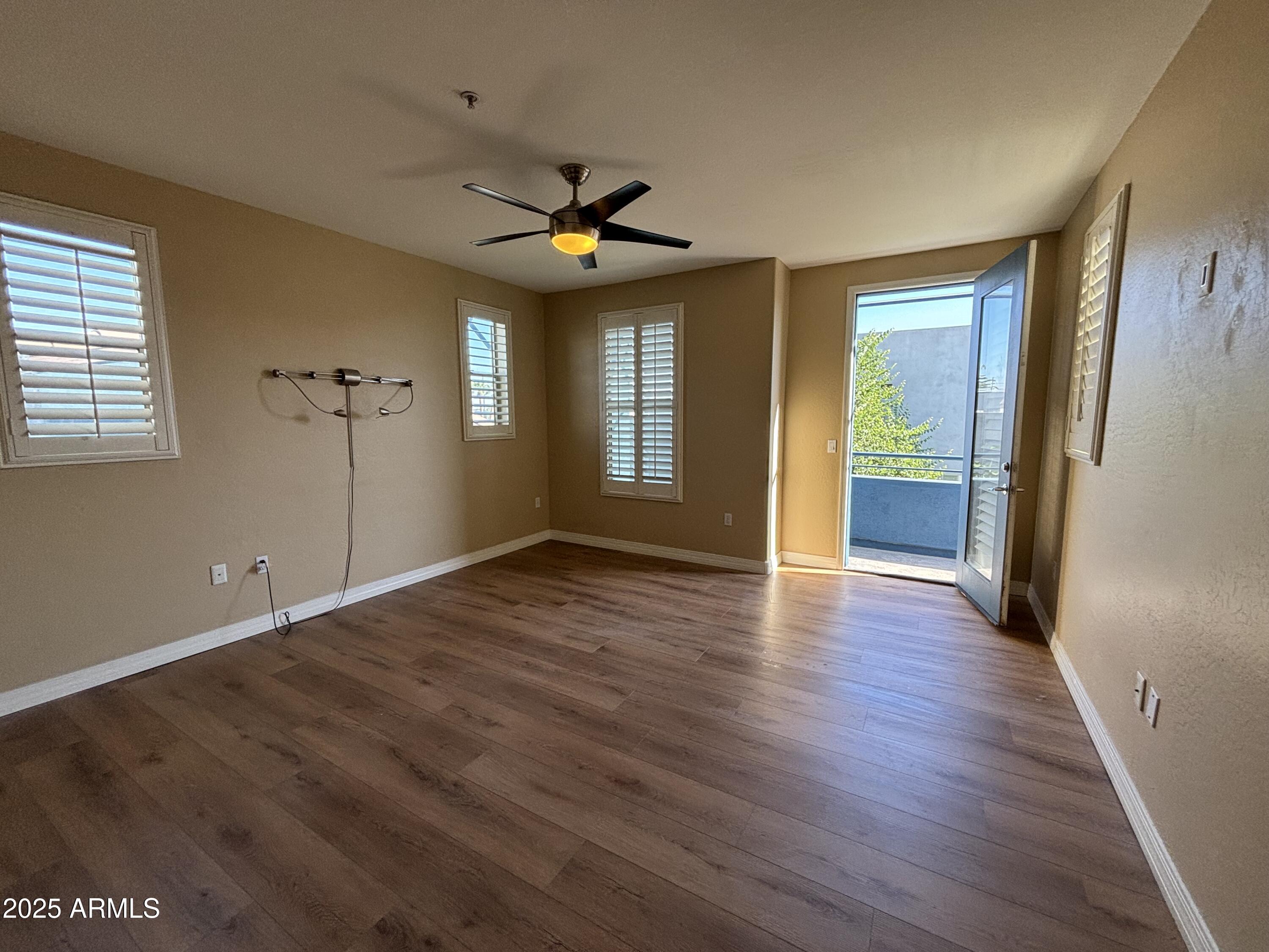 615 East Portland Street, Unit 113 Phoenix, AZ 85004 - Photo 15 of 28 a view of an empty room with window and wooden floor