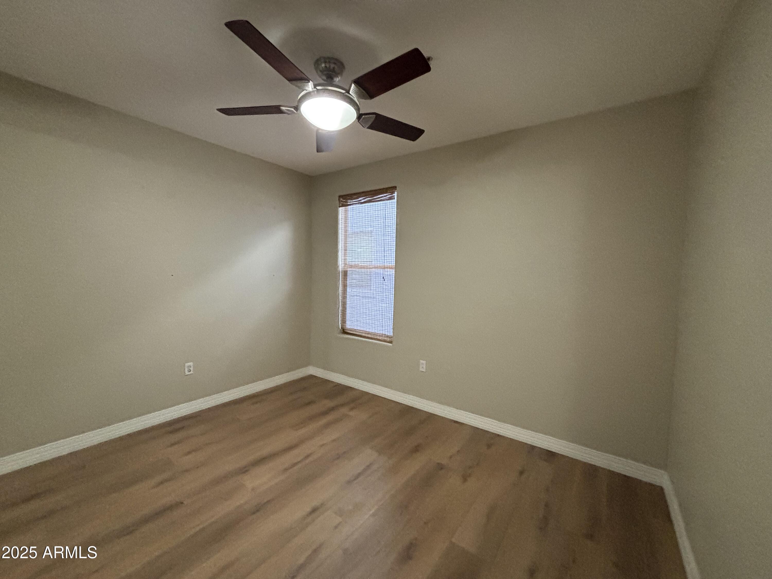 615 East Portland Street, Unit 113 Phoenix, AZ 85004 - Photo 20 of 28 an empty room with wooden floor and windows