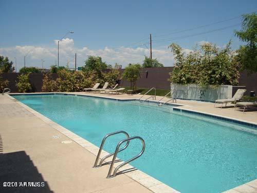 615 East Portland Street, Unit 113 Phoenix, AZ 85004 - Photo 27 of 28 a view of a swimming pool with a yard and plants