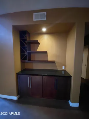 a kitchen with stainless steel appliances granite countertop wooden cabinets and a stove top oven