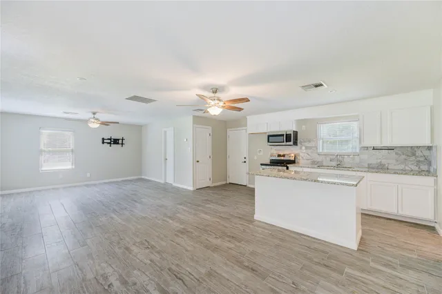 a view of a kitchen with a sink and microwave