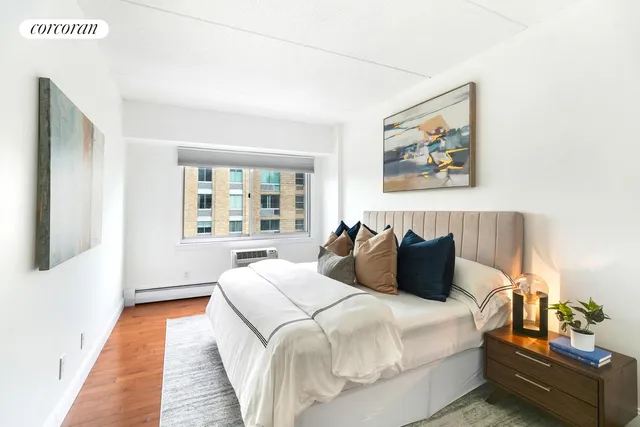 a bedroom with bed and night stand