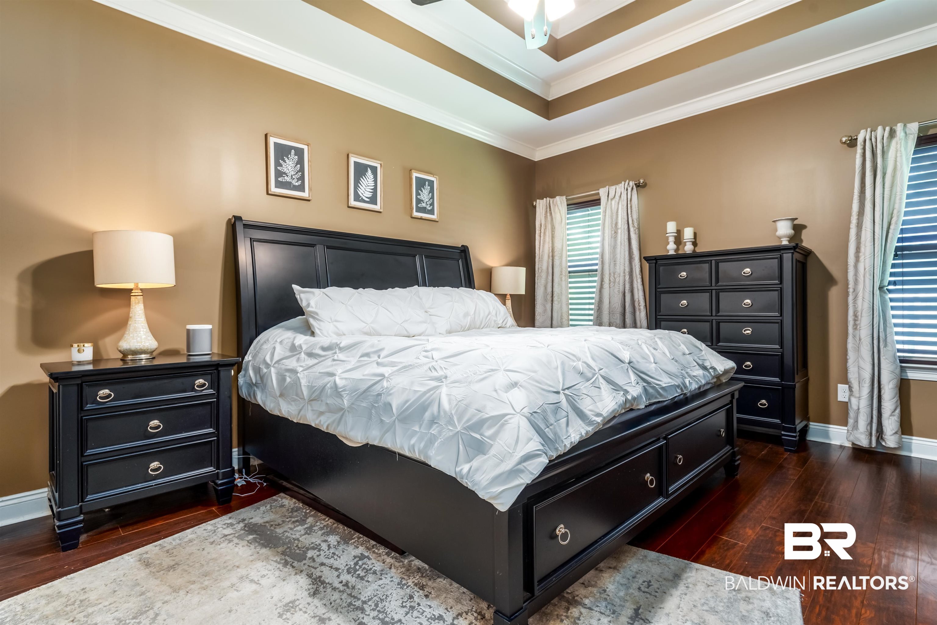 965 Henckley Avenue Mobile, AL 36609 - Photo 11 of 30 Bedroom featuring dark hardwood / wood-style flooring, crown molding, and a tray ceiling