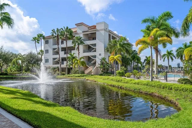 a view of a lake with a big yard and palm trees