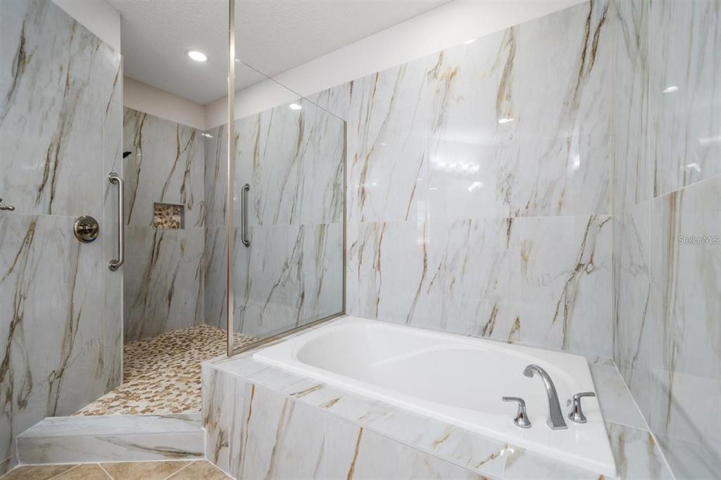 1030 Bellasol Way, Unit 201 Apollo Beach, FL 33572 - Photo 20 of 36 a bathroom with a bathtub and shower