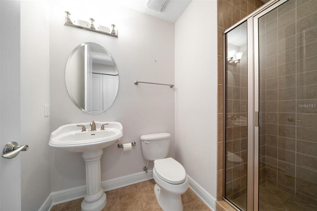 1030 Bellasol Way, Unit 201 Apollo Beach, FL 33572 - Photo 22 of 36 a bathroom with a sink toilet and a mirror