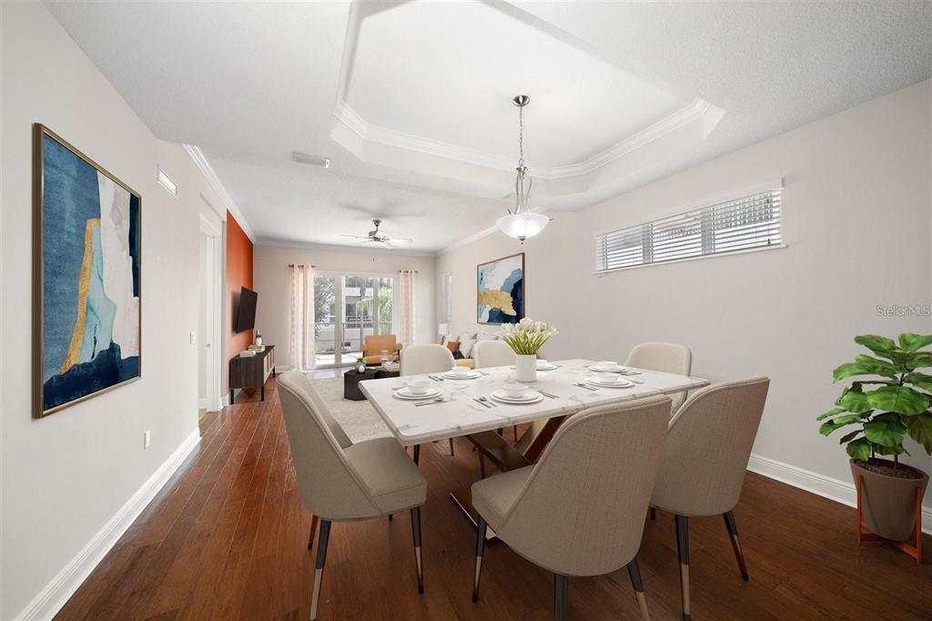 1030 Bellasol Way, Unit 201 Apollo Beach, FL 33572 - Photo 4 of 36 a view of a dining room with furniture window and wooden floor