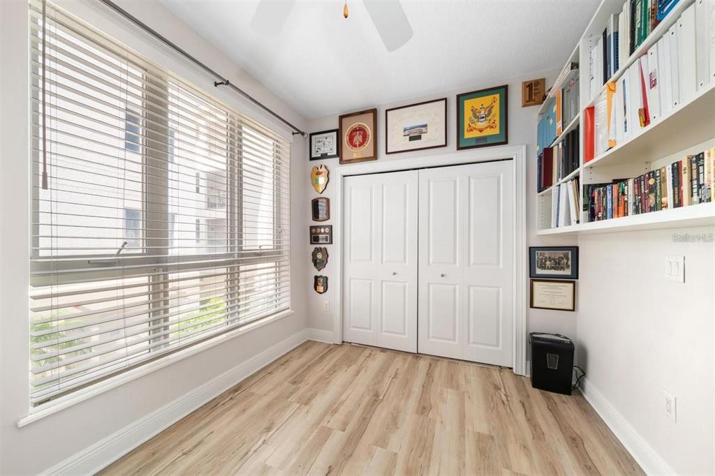 1030 Bellasol Way, Unit 201 Apollo Beach, FL 33572 - Photo 5 of 36 a view of a bedroom with wooden floor and a window