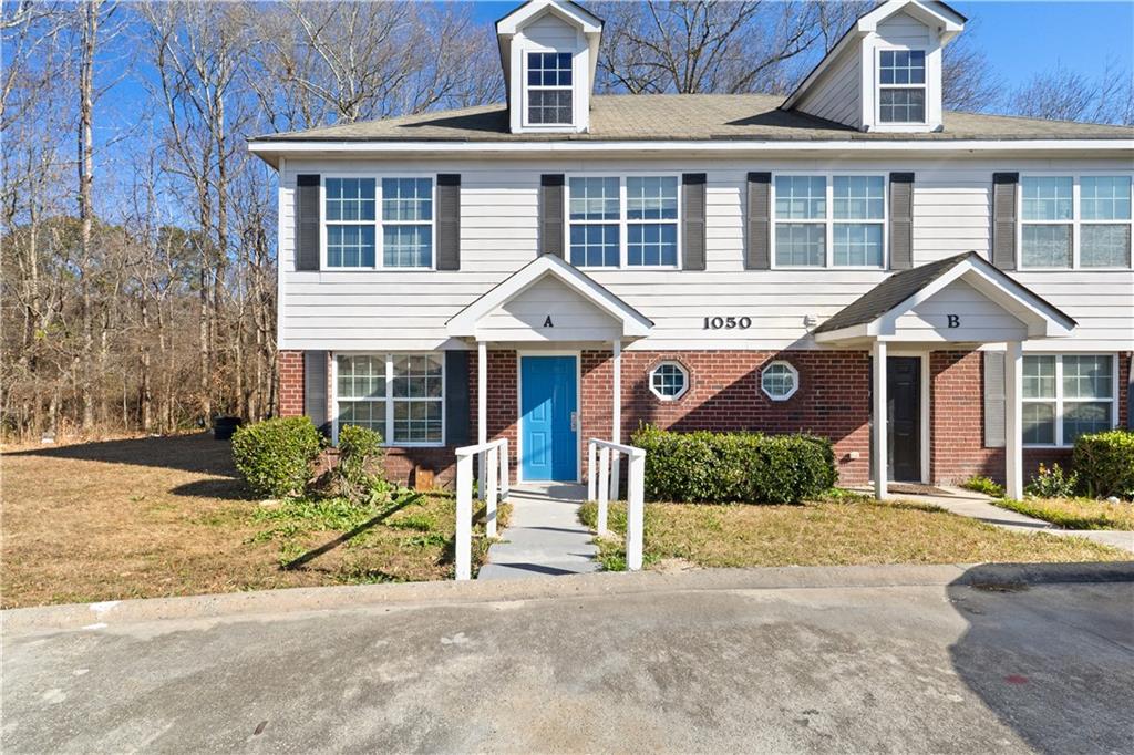 1050 Wheel House Lane Monroe, GA 30655 - Photo 2 of 15 a front view of a house with a yard and potted plants