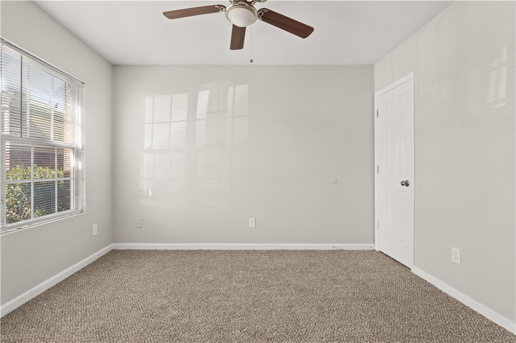 1050 Wheel House Lane Monroe, GA 30655 - Photo 4 of 15 an empty room with a window and a fan