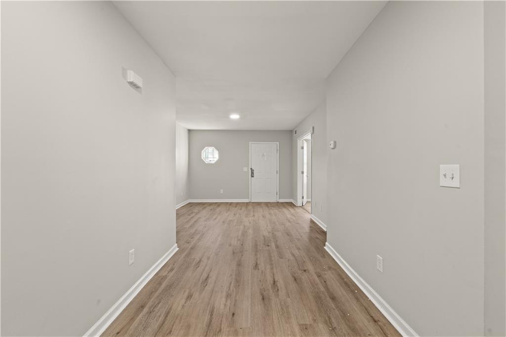 1050 Wheel House Lane Monroe, GA 30655 - Photo 5 of 15 a view of a room with wooden floor and white walls
