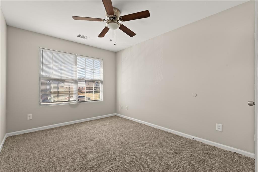 1050 Wheel House Lane Monroe, GA 30655 - Photo 7 of 15 an empty room with a window and a fan