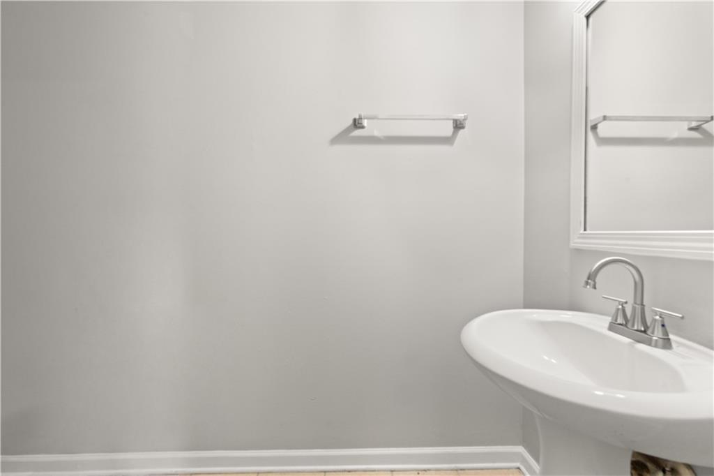 1050 Wheel House Lane Monroe, GA 30655 - Photo 8 of 15 a bathroom with a sink and mirror