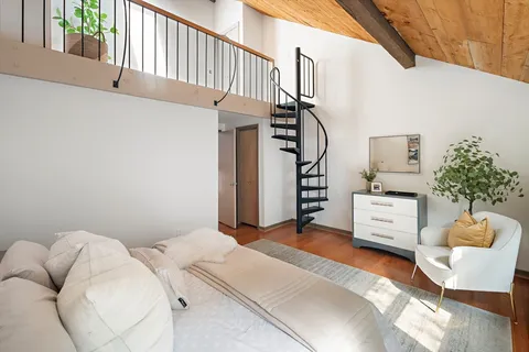 a bedroom with furniture and a baby crib