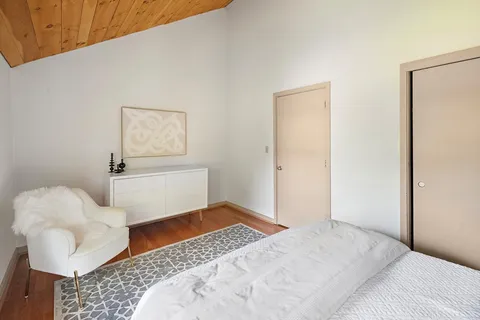 a bedroom with a bed and chair