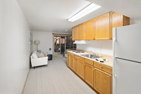 a kitchen with stainless steel appliances granite countertop a refrigerator a oven a sink and a refrigerator