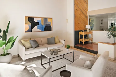 a living room with furniture and wooden floor