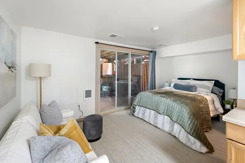 a bedroom with a bed and glass window