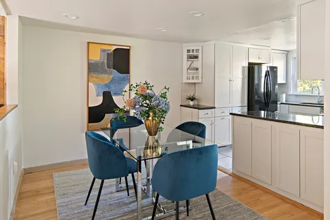 a dining room with furniture and wooden floor