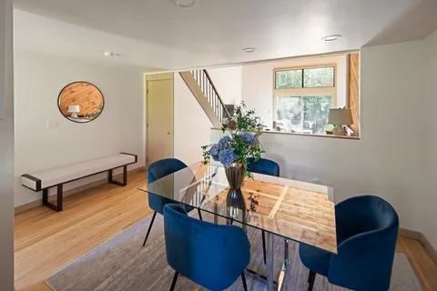 a view of a dining room with furniture window and wooden floor