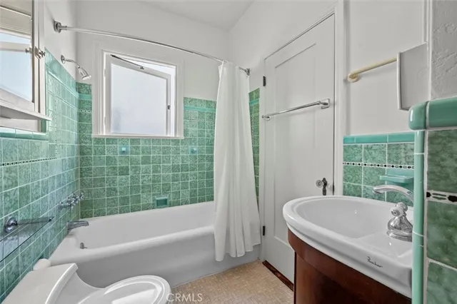 a bathroom with a tub a sink and a shower
