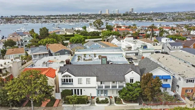 an aerial view of residential houses with outdoor space and ocean view