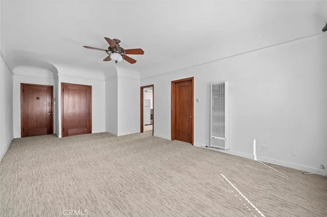 a view of empty room with ceiling fan