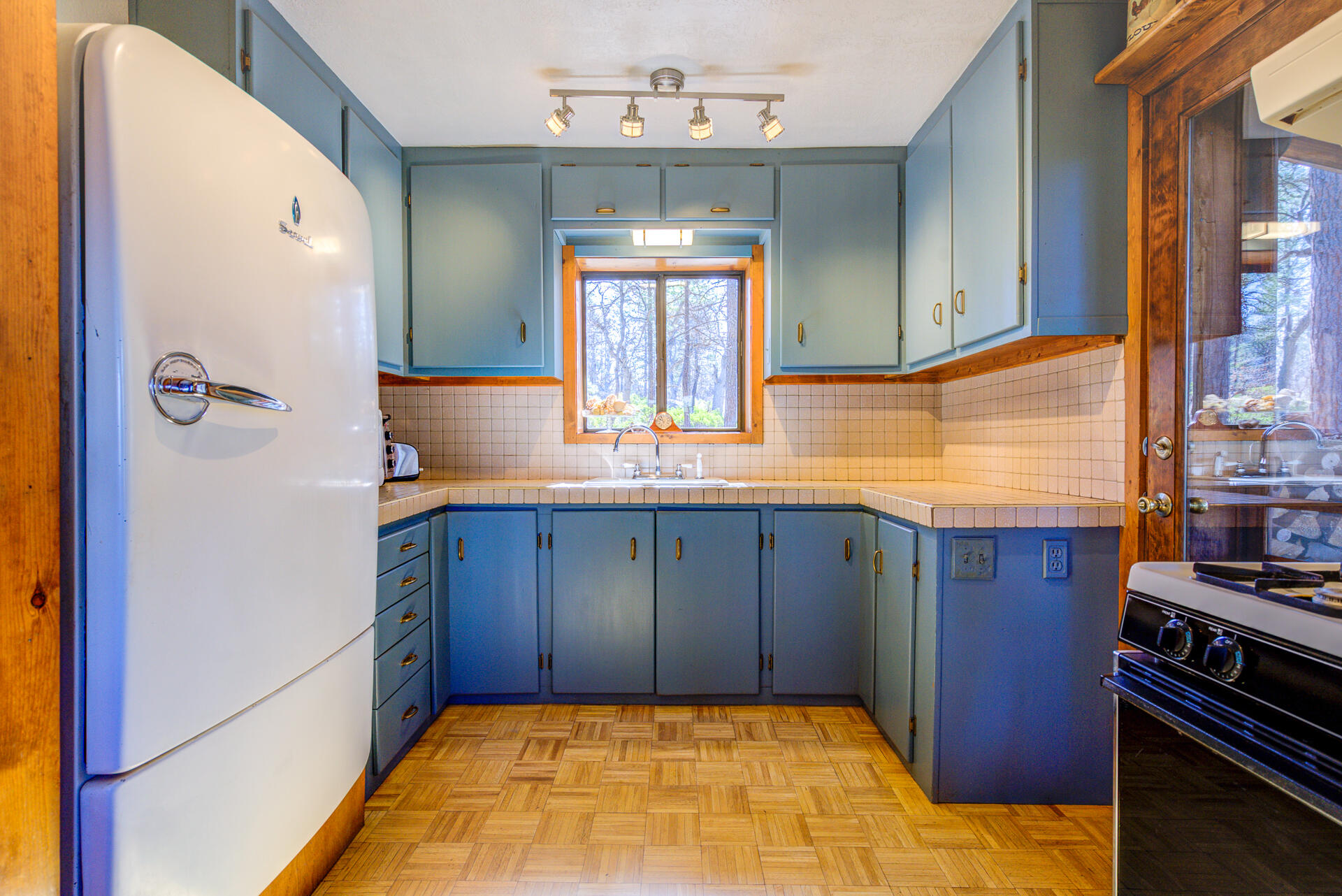 547-705 Old Hwy Road McArthur, CA 96056 - Photo 19 of 62 a kitchen with wooden cabinets and a stove
