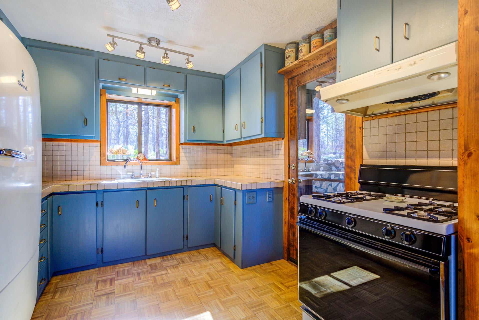 547-705 Old Hwy Road McArthur, CA 96056 - Photo 20 of 62 a kitchen with wooden cabinets and a stove top oven