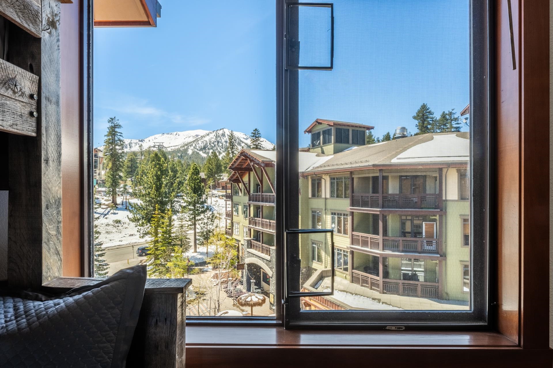 6201 Minaret Road, Unit 2430 Mammoth Lakes, CA 93546 - Photo 32 of 44 Wood-framed window with a multi-pane design, offering expansive views of snow-covered mountains, eve