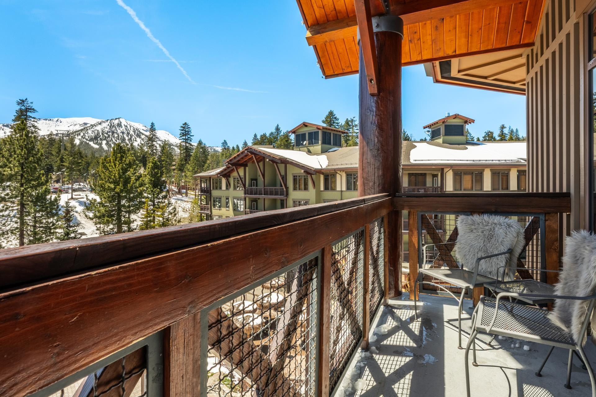 6201 Minaret Road, Unit 2430 Mammoth Lakes, CA 93546 - Photo 6 of 44 Balcony featuring a wood and metal railing, exposed wood beams, and a wood plank ceiling