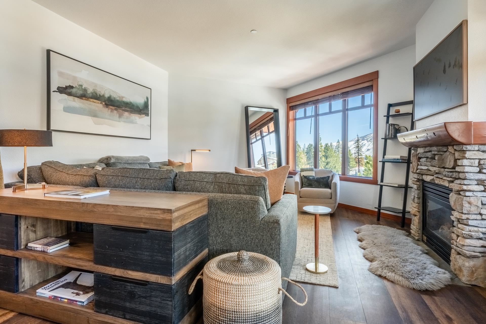 6201 Minaret Road, Unit 2430 Mammoth Lakes, CA 93546 - Photo 8 of 44 Living room with warm wood-finish flooring and a stone-clad fireplace featuring a wood mantel