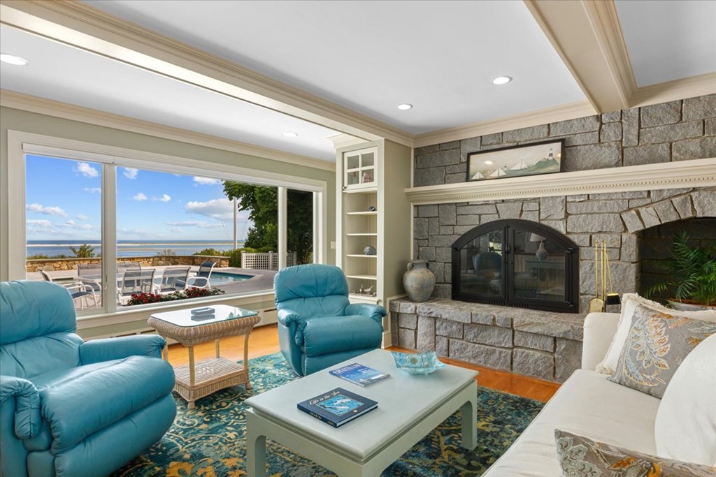 500 Shore Road Chatham, MA 02633 - Photo 5 of 32 a living room with furniture a fireplace and a flat screen tv