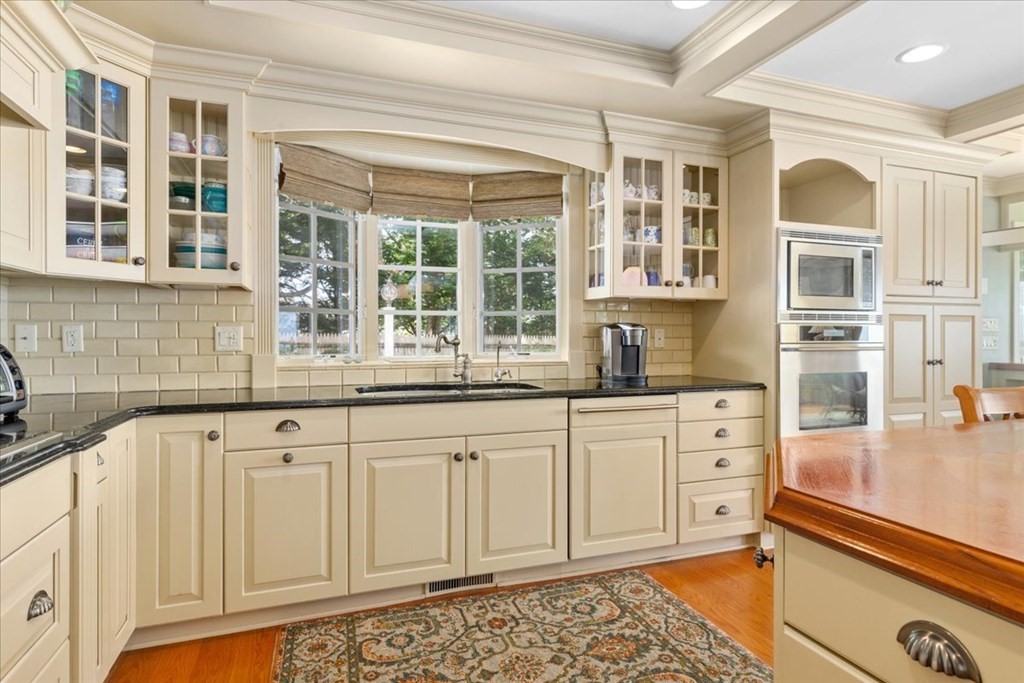500 Shore Road Chatham, MA 02633 - Photo 7 of 32 a kitchen with granite countertop white cabinets and a window