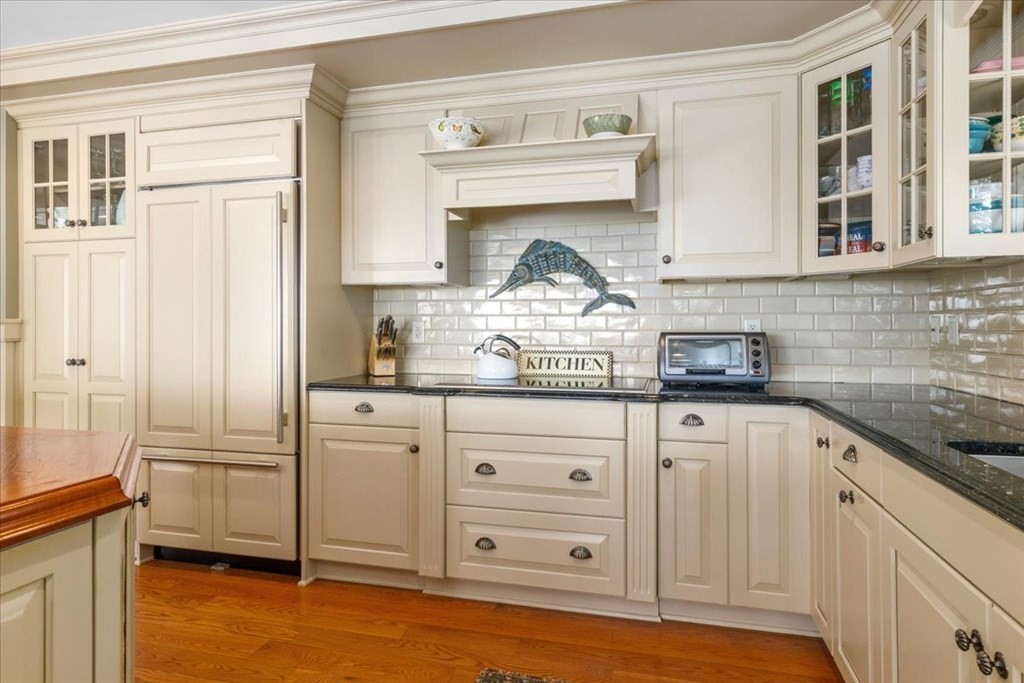 500 Shore Road Chatham, MA 02633 - Photo 8 of 32 a kitchen with granite countertop white cabinets and white appliances