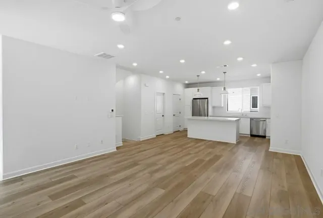 a view of kitchen with refrigerator and white floor