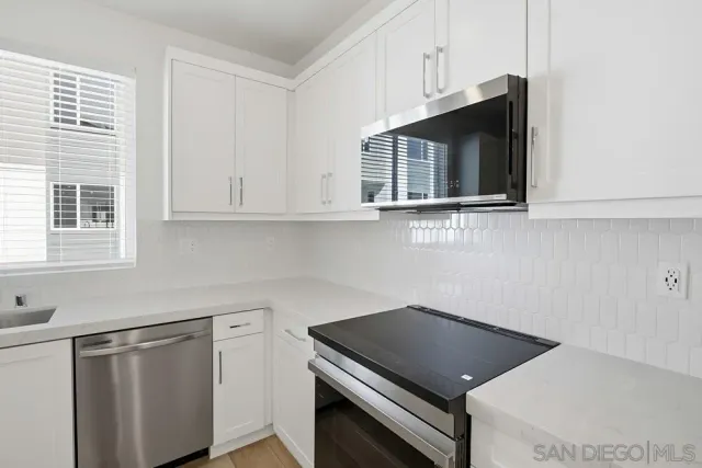 a kitchen with a sink cabinets and stainless steel appliances