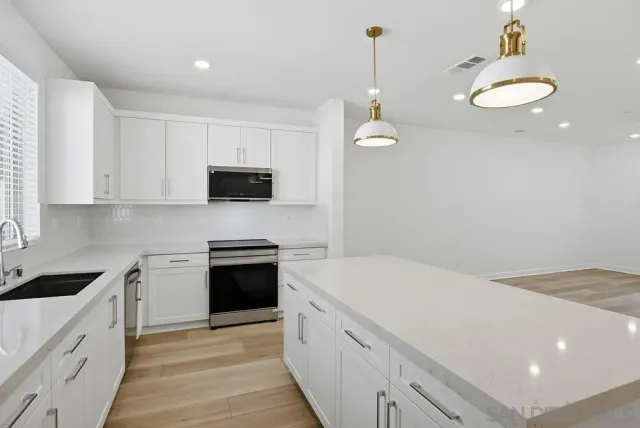 a kitchen with a stove and a refrigerator