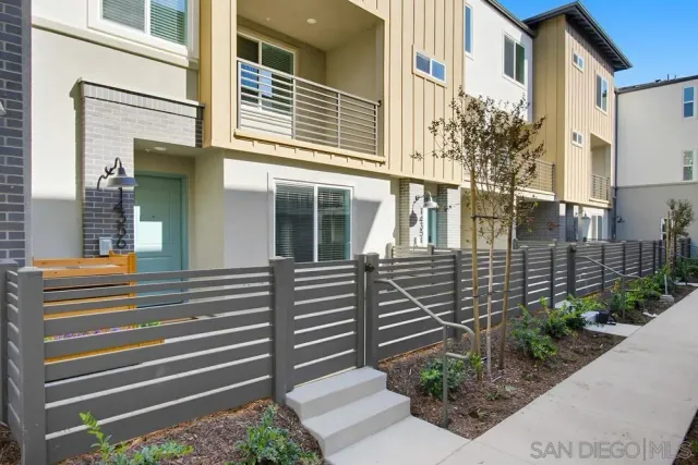 a view of a house with potted plants