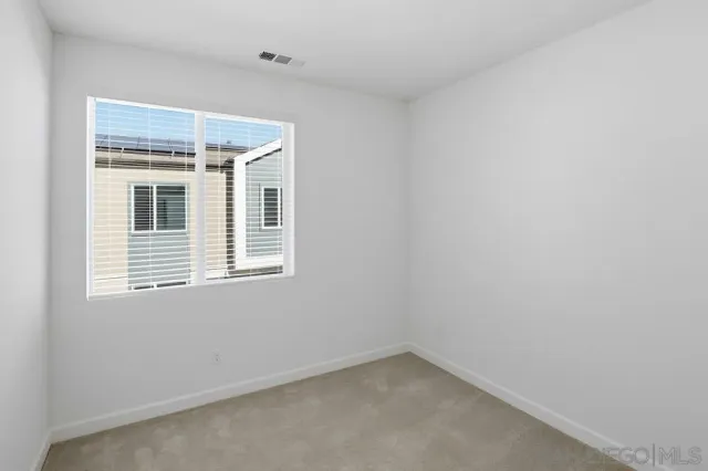 a view of a balcony with wooden floor and fence