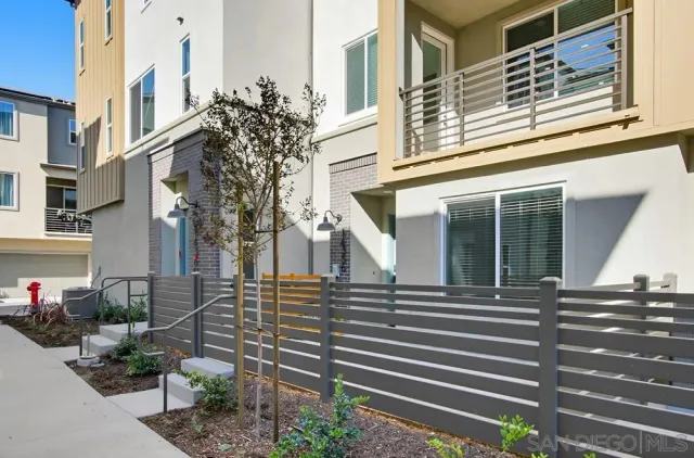 a view of a house with a window and potted plants