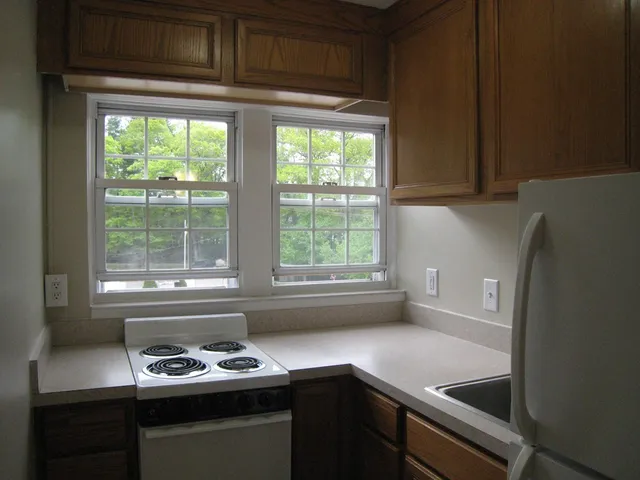 a kitchen with a window a sink and a stove