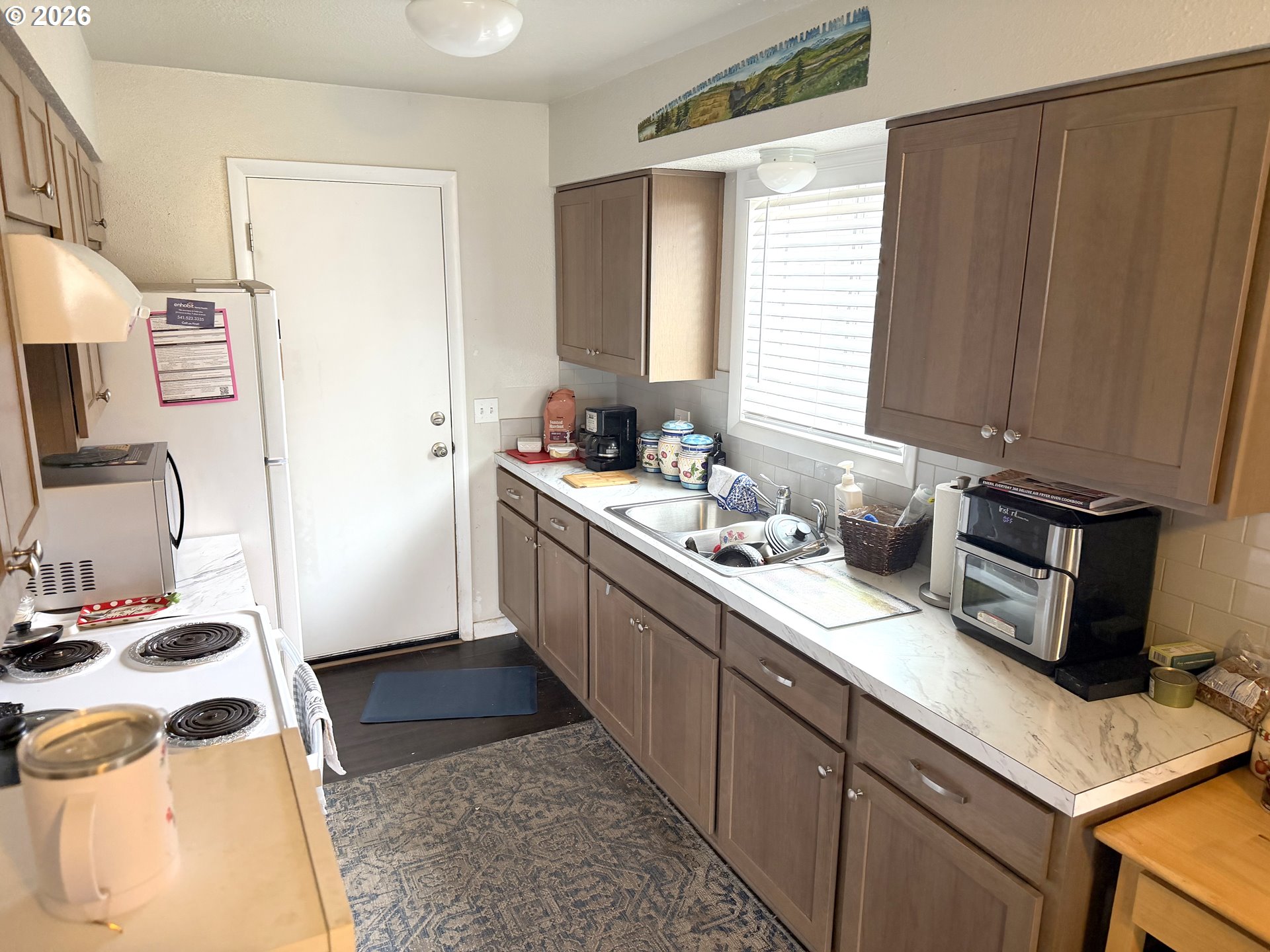 2735-2745 Myrtle Street Baker City, OR 97814 - Photo 11 of 27 a kitchen with a sink and a stove top oven