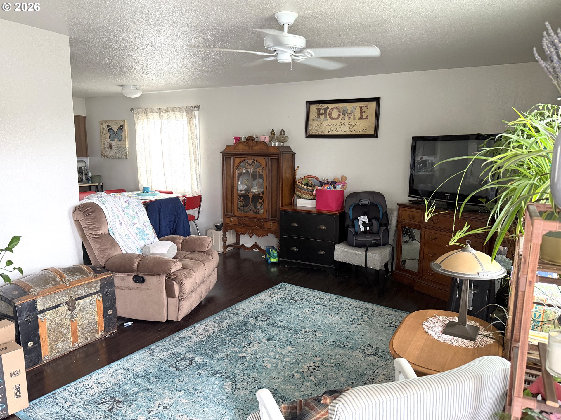 2735-2745 Myrtle Street Baker City, OR 97814 - Photo 2 of 27 a living room with furniture a chandelier and a fireplace