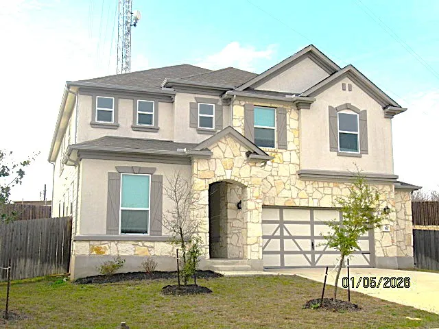 a front view of a house with a yard