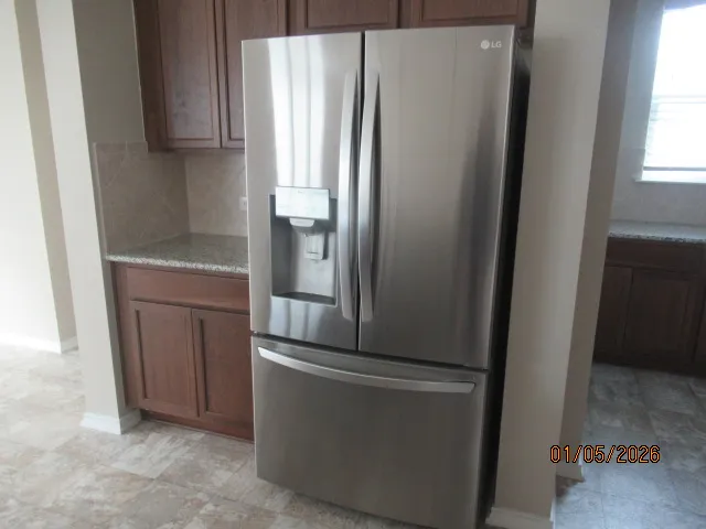 a kitchen with metallic refrigerator freezer and a dishwasher