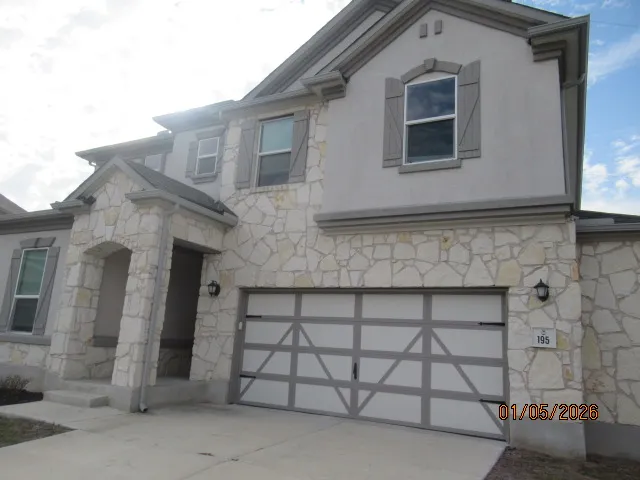 a front view of a house with a garage